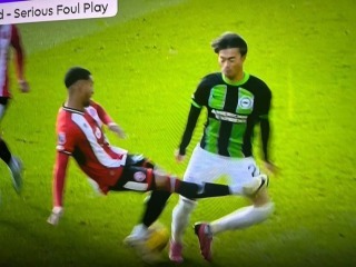 Mitoma Mason Holgate (Sheffield United) is shown the red card